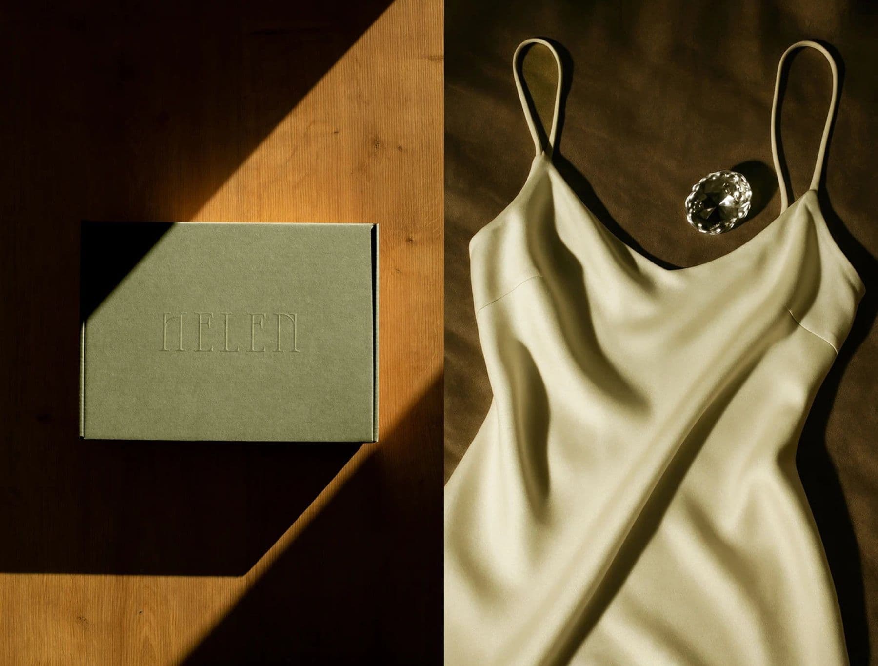 Helen olive card box beside a satin slip dress